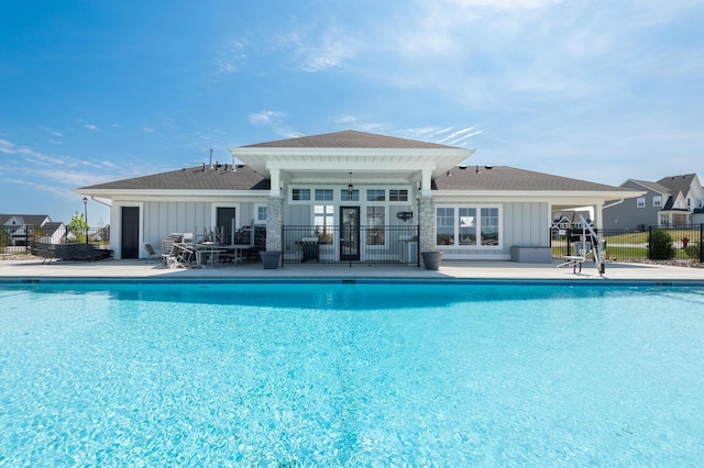view of swimming pool featuring fence and a patio