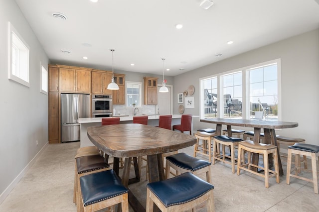 dining space featuring recessed lighting and baseboards