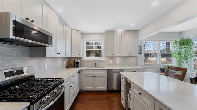 65770 Big Pine Rd, Finlayson, MN 55735 - kitchen featuring stainless steel appliances, light countertops, decorative backsplash, and recessed lighting
