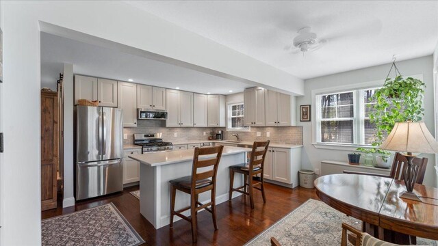 65770 Big Pine Rd, Finlayson, MN 55735 - kitchen featuring appliances with stainless steel finishes, light countertops, a kitchen bar, healthy amount of natural light, and recessed lighting