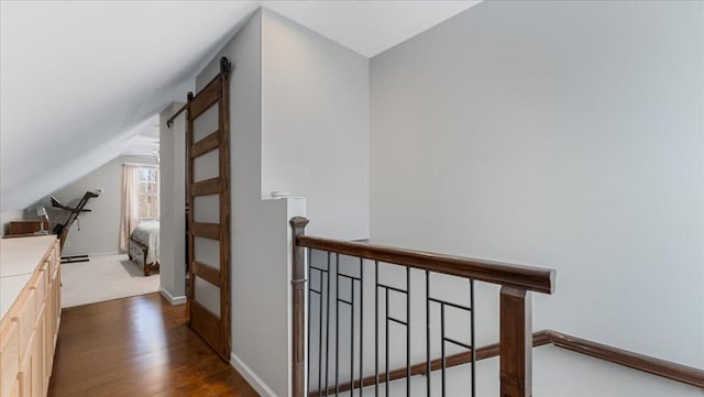 65770 Big Pine Rd, Finlayson, MN 55735 - hallway featuring an upstairs landing, lofted ceiling, dark wood-style floors, and a barn door