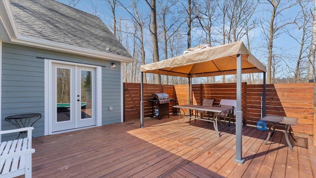 65770 Big Pine Rd, Finlayson, MN 55735 - wooden terrace with a grill, outdoor dining space, a gazebo, a fenced backyard, and french doors