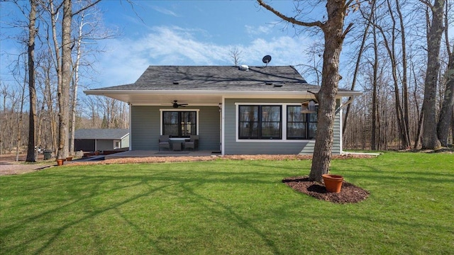 65770 Big Pine Rd, Finlayson, MN 55735 - back of property featuring a ceiling fan, a lawn, a patio area, and an outdoor structure