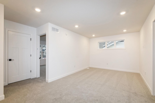 below grade area featuring light colored carpet, baseboards, and recessed lighting
