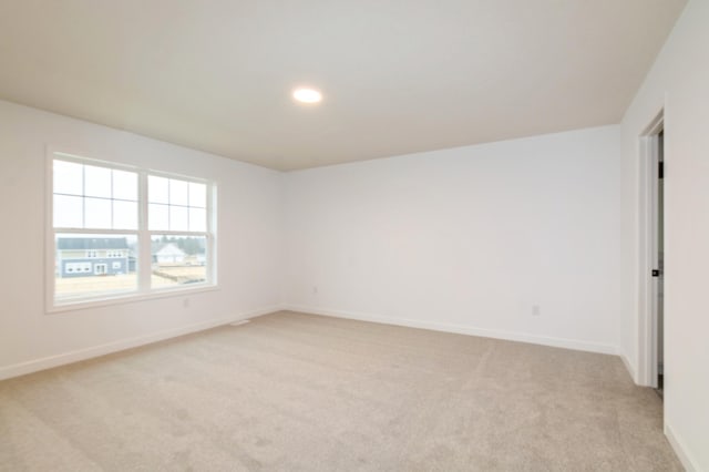 unfurnished room featuring light colored carpet, baseboards, and recessed lighting