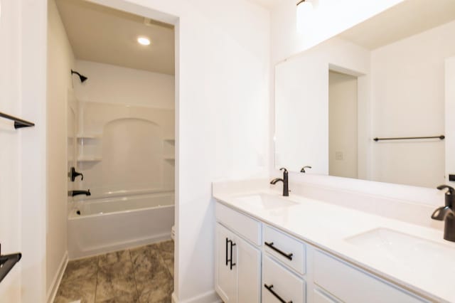 full bathroom with baseboards, double vanity,  shower combination, recessed lighting, and toilet