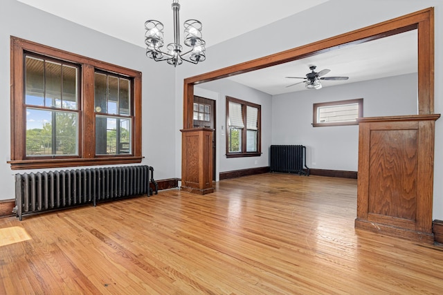 604 Asbury St, Saint Paul, MN 55104 - unfurnished room featuring radiator, light wood-style floors, and a chandelier
