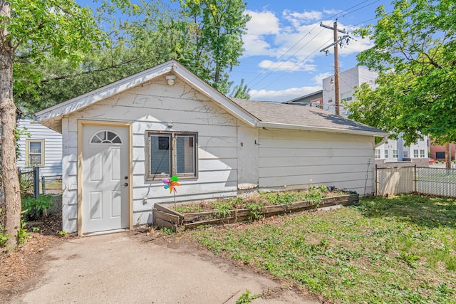 604 Asbury St, Saint Paul, MN 55104 - view of front of home with fence, a vegetable garden, and a shingled roof