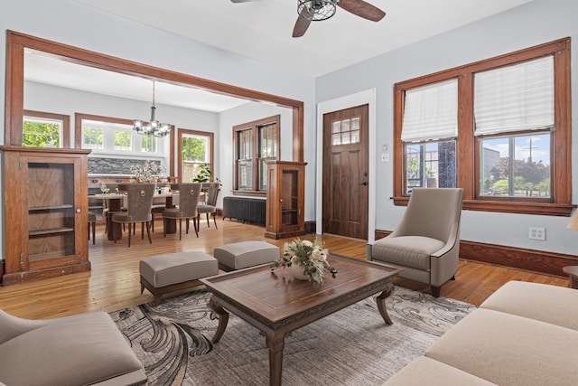 604 Asbury St, Saint Paul, MN 55104 - living area featuring light wood-style floors, a chandelier, healthy amount of natural light, and a ceiling fan