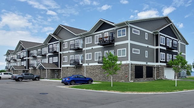 715 Lake Shore Dr NE Unit 105, Bemidji, MN 56601 - view of apartment building / complex featuring uncovered parking