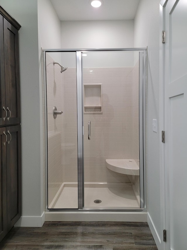 715 Lake Shore Dr NE Unit 105, Bemidji, MN 56601 - bathroom featuring wood finished floors, a stall shower, baseboards, and recessed lighting
