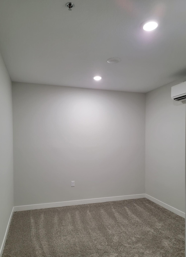 715 Lake Shore Dr NE Unit 105, Bemidji, MN 56601 - carpeted empty room with a wall mounted AC, baseboards, recessed lighting, and fire sprinkler in ceiling
