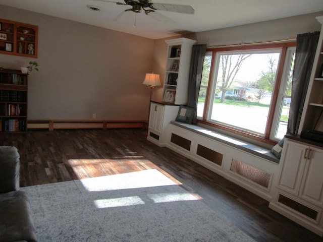 318 3rd St, Dawson, MN 56232 - empty room featuring wood finished floors, ceiling fan, and baseboard heating