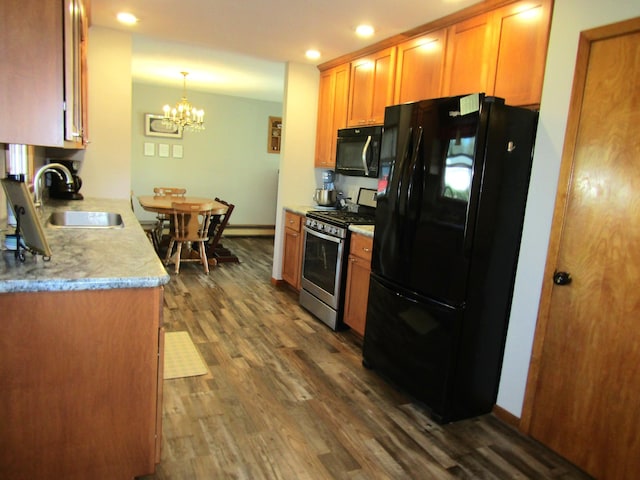 318 3rd St, Dawson, MN 56232 - kitchen featuring black appliances, a sink, dark wood-style flooring, a chandelier, and recessed lighting