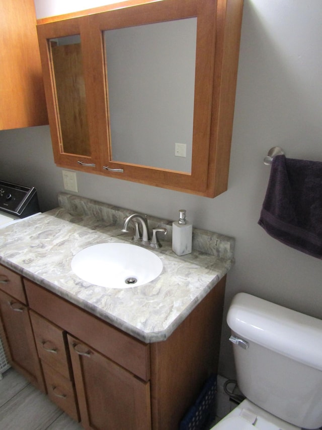 318 3rd St, Dawson, MN 56232 - bathroom with vanity and toilet