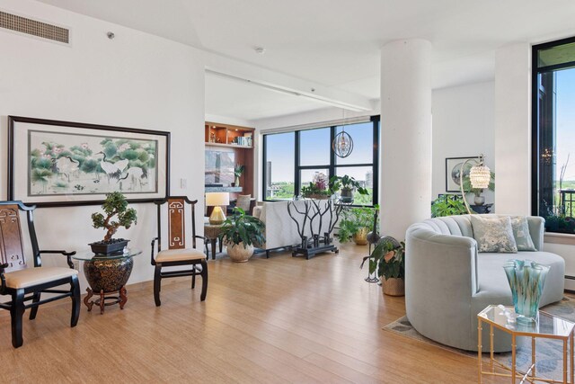 215 10th Ave S Unit 812, Minneapolis, MN 55415 - sitting room featuring wood finished floors and healthy amount of natural light