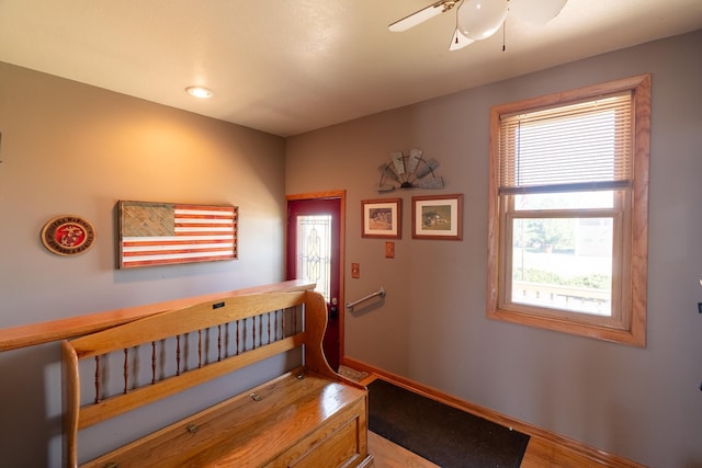corridor featuring baseboards and wood finished floors
