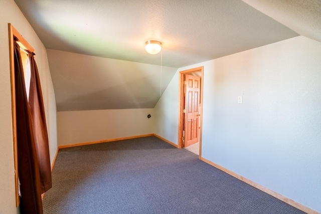 bonus room with lofted ceiling, carpet flooring, and baseboards