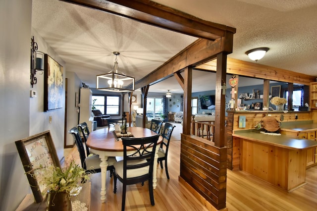 5151 99th Ave, Clear Lake, MN 55319 - dining space with a textured ceiling, light wood-style flooring, and a chandelier