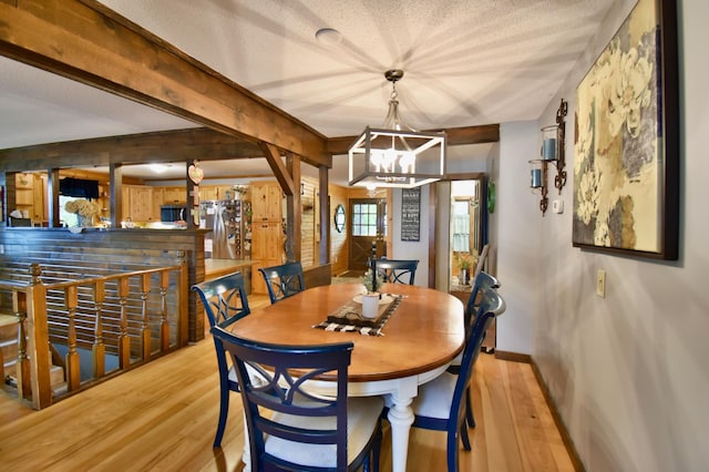 5151 99th Ave, Clear Lake, MN 55319 - dining room featuring light wood-type flooring, a chandelier, baseboards, a textured ceiling, and beamed ceiling