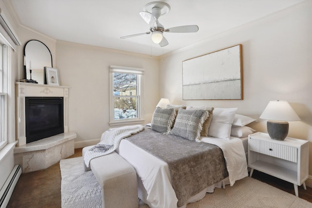 bedroom with a baseboard radiator, crown molding, a glass covered fireplace, ceiling fan, and baseboards