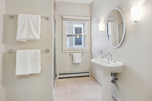 bathroom with baseboard heating, a shower with shower door, baseboards, and tile patterned flooring