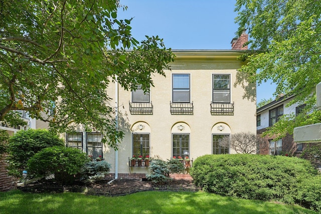 1770 James Ave S Unit 1, Minneapolis, MN 55403 - view of front of property featuring a chimney and stucco siding