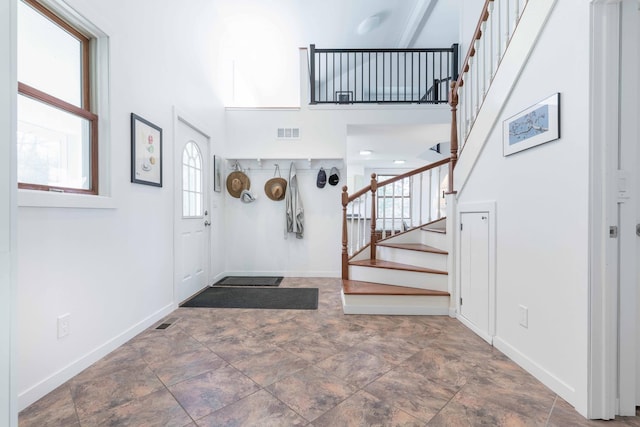 15126 Tumuli Rd, Dalton, MN 56324 - foyer featuring stairway, a high ceiling, and baseboards