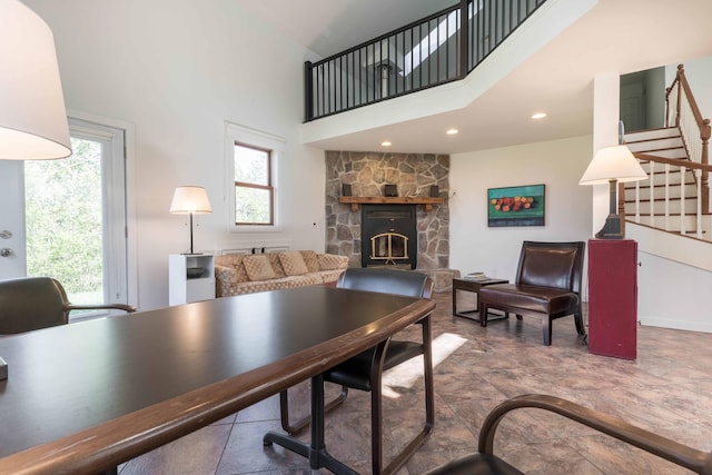 15126 Tumuli Rd, Dalton, MN 56324 - living area featuring a towering ceiling, a fireplace, and stairs