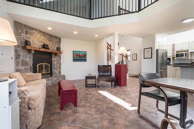 15126 Tumuli Rd, Dalton, MN 56324 - living area featuring a high ceiling, a stone fireplace, recessed lighting, baseboards, and stairs