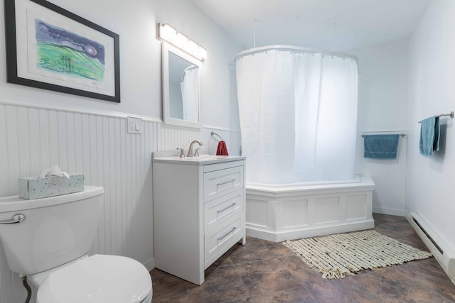 15126 Tumuli Rd, Dalton, MN 56324 - bathroom with a baseboard radiator, toilet, a wainscoted wall, vanity, and stone finish floors