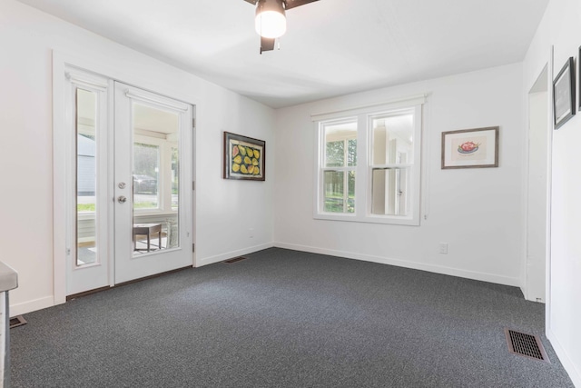 15126 Tumuli Rd, Dalton, MN 56324 - unfurnished room with dark colored carpet, baseboards, and a ceiling fan