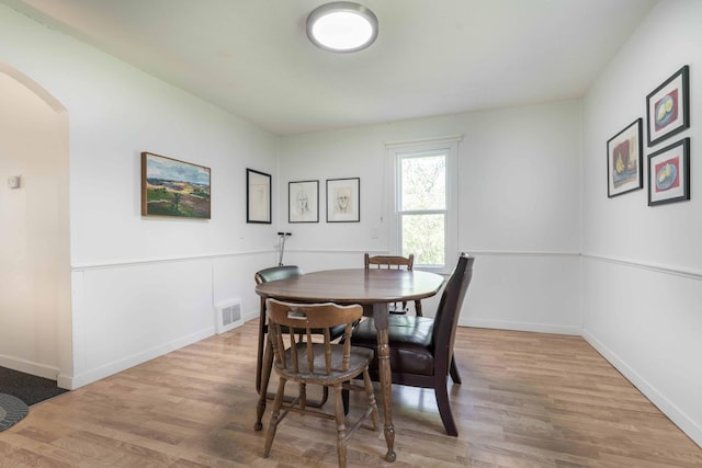 15126 Tumuli Rd, Dalton, MN 56324 - dining area with arched walkways, wood finished floors, and baseboards