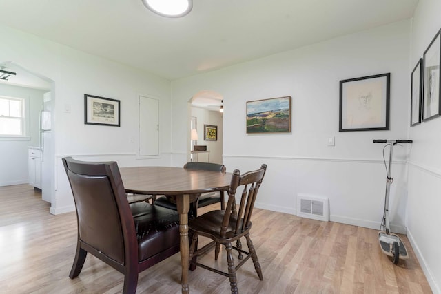 15126 Tumuli Rd, Dalton, MN 56324 - dining room with arched walkways, light wood-type flooring, and baseboards