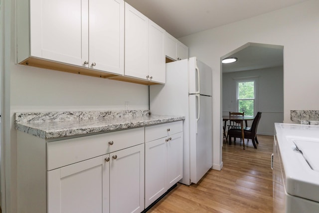 15126 Tumuli Rd, Dalton, MN 56324 - kitchen with light wood finished floors, white cabinetry, and freestanding refrigerator