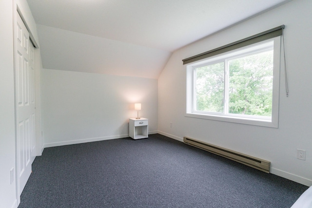 15126 Tumuli Rd, Dalton, MN 56324 - bonus room featuring a baseboard heating unit, lofted ceiling, dark colored carpet, and baseboards