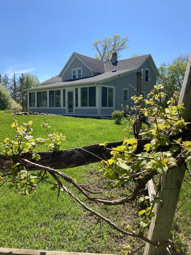 15126 Tumuli Rd, Dalton, MN 56324 - rear view of house with a yard, a sunroom, and a chimney