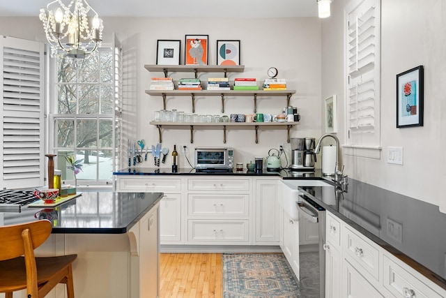 421 Summit Ave Unit 2, Saint Paul, MN 55102 - bar with a sink, dishwasher, a chandelier, light wood-style flooring, and pendant lighting