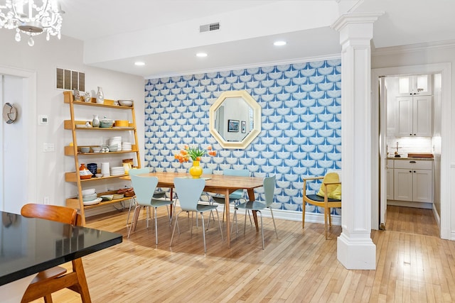 421 Summit Ave Unit 2, Saint Paul, MN 55102 - dining space with decorative columns, an accent wall, light wood-type flooring, crown molding, and recessed lighting