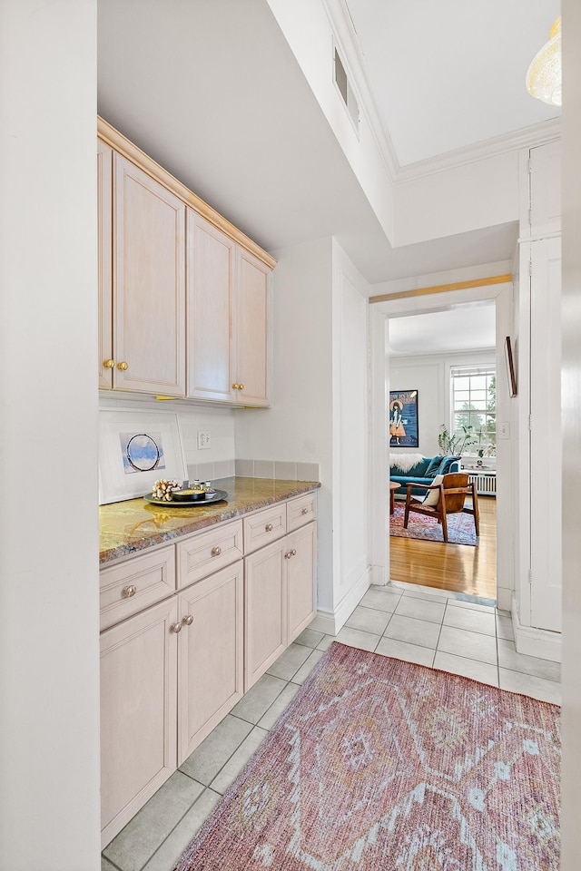 421 Summit Ave Unit 2, Saint Paul, MN 55102 - kitchen featuring light tile patterned flooring, light stone counters, ornamental molding, and light brown cabinets