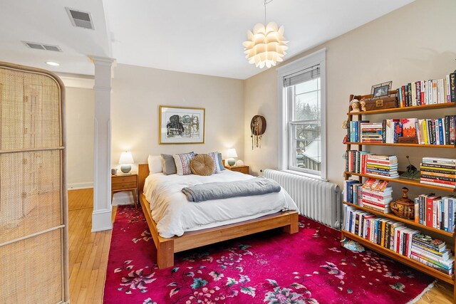 421 Summit Ave Unit 2, Saint Paul, MN 55102 - bedroom with radiator and wood finished floors