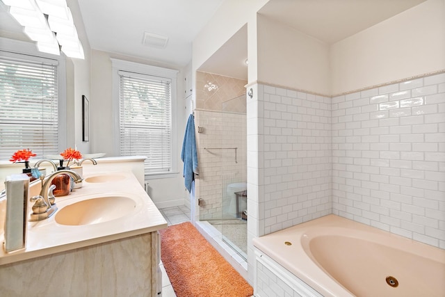 421 Summit Ave Unit 2, Saint Paul, MN 55102 - full bath featuring a stall shower, a tub with jets, tile patterned flooring, and double vanity