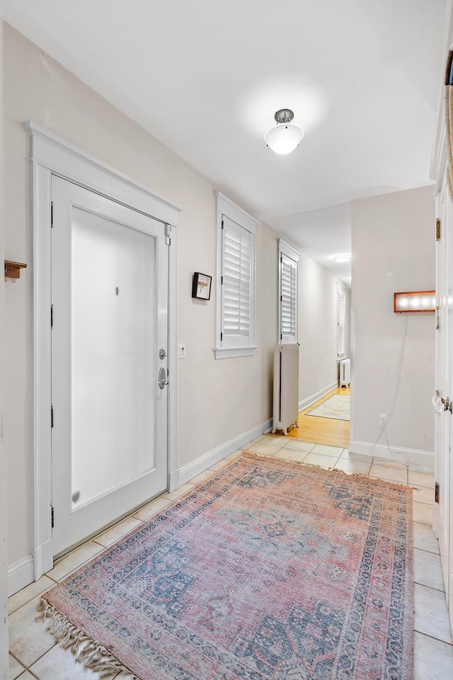 421 Summit Ave Unit 2, Saint Paul, MN 55102 - foyer with light tile patterned floors, baseboards, and radiator