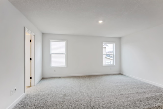 unfurnished room featuring carpet flooring, baseboards, healthy amount of natural light, and recessed lighting