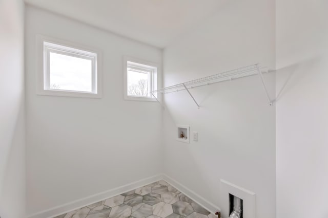 laundry area with baseboards and washer hookup