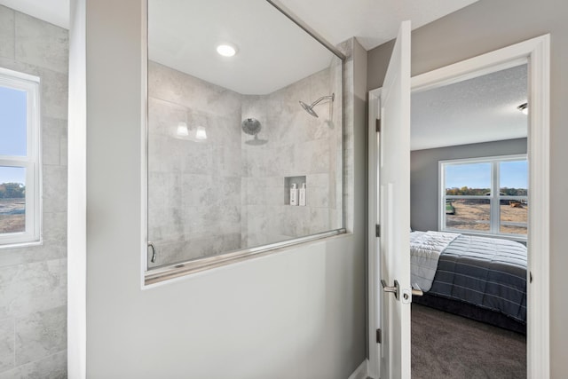 ensuite bathroom featuring a tile shower