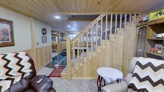 109 Gray Pl W, Marshall, MN 56258 - staircase featuring wooden walls, wood ceiling, a wainscoted wall, and carpet