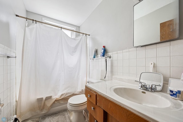 bathroom featuring shower / bath combo, tile walls, toilet, vanity, and tasteful backsplash