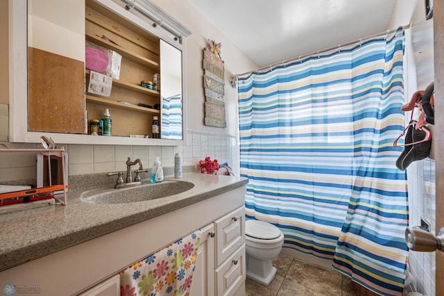full bathroom with toilet, vanity, tile walls, a shower with curtain, and tile patterned floors