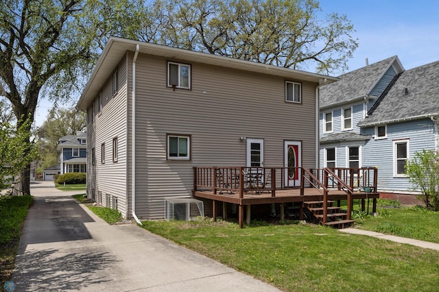 back of house featuring a yard and a deck